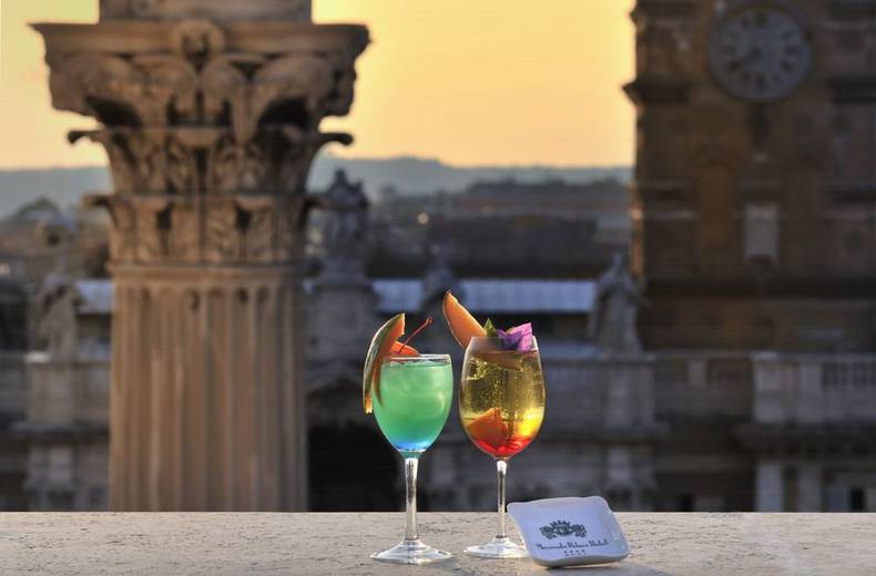 Enjoy a delicious cocktail or an aperitif while watching the sunset over the historic skyline ... Mecenate Palace Hotel Rome